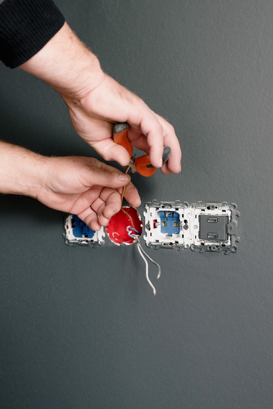 Electrician testing wiring with a meter
